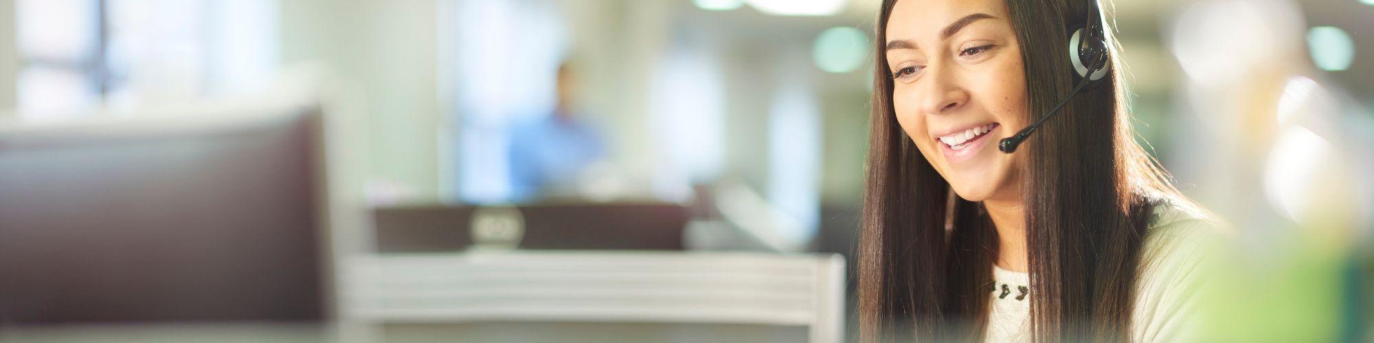 Woman with 211 in a call center helping a client