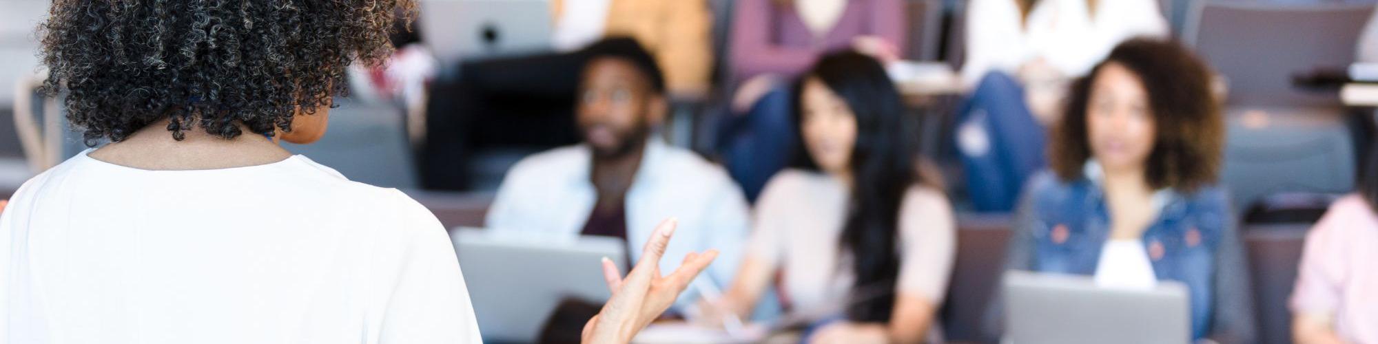 Woman giving a presentation to coworkers about workplace giving